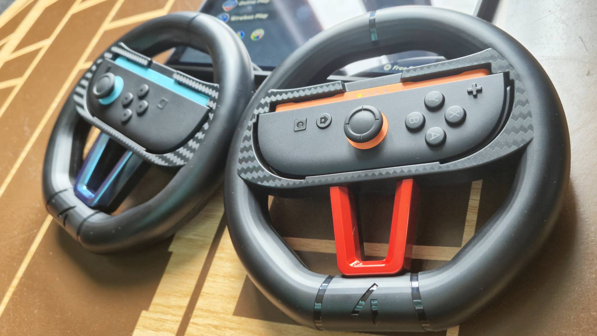 Photo by Rosalie Newcombe of the 4gamer (STEALTH) Switch 2 Twin Racing Wheel controllers sitting on a wooden coffee table.