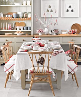 Dinning room table with white cloth and traditional festive decorfation