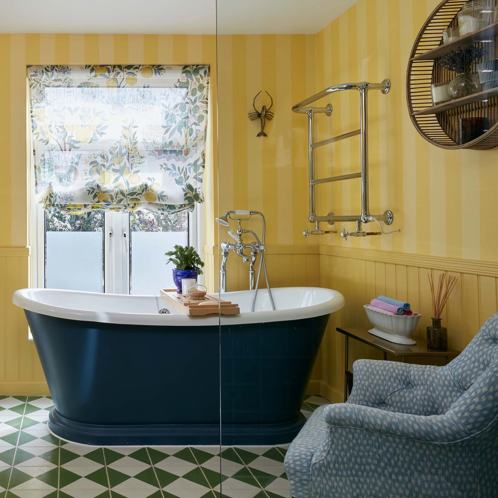 black bateau bath in yellow bathroom with armchair