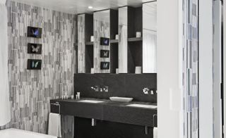 Bathroom with designed walls and grey wash basin
