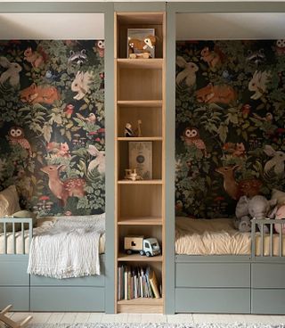 A bookcase built in the middle of two beds in a shared kids' bedroom