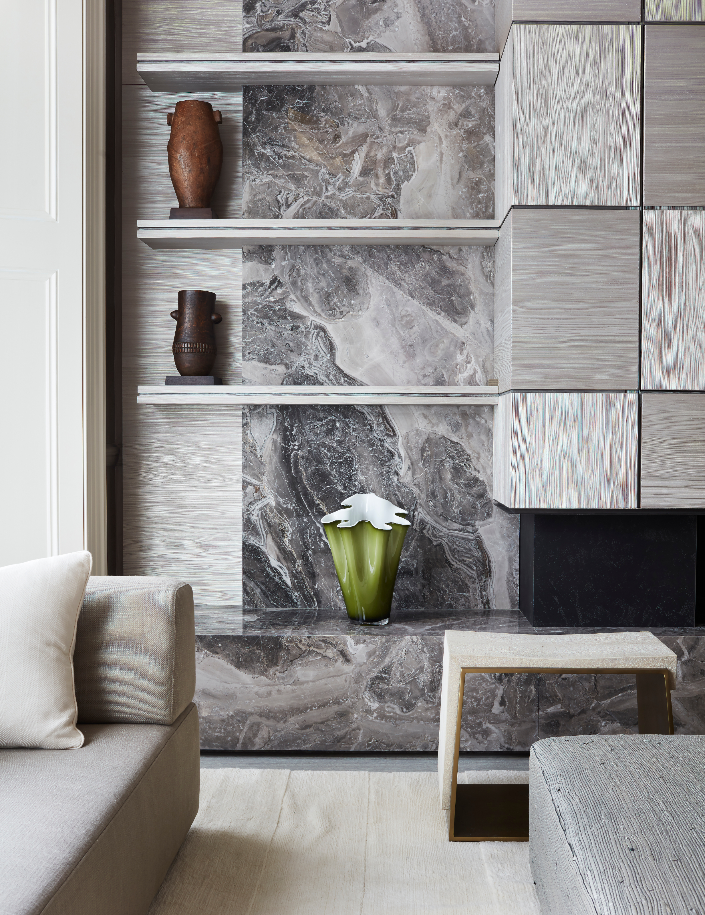 Grey living room with stone fireplace and built-in shelving