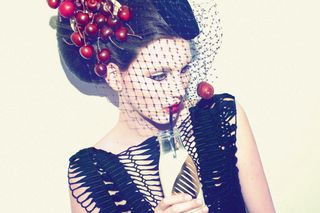 cherry-inspired headpiece from milliner Piers Atkinson coupled with a Pringle of Scotland dress
