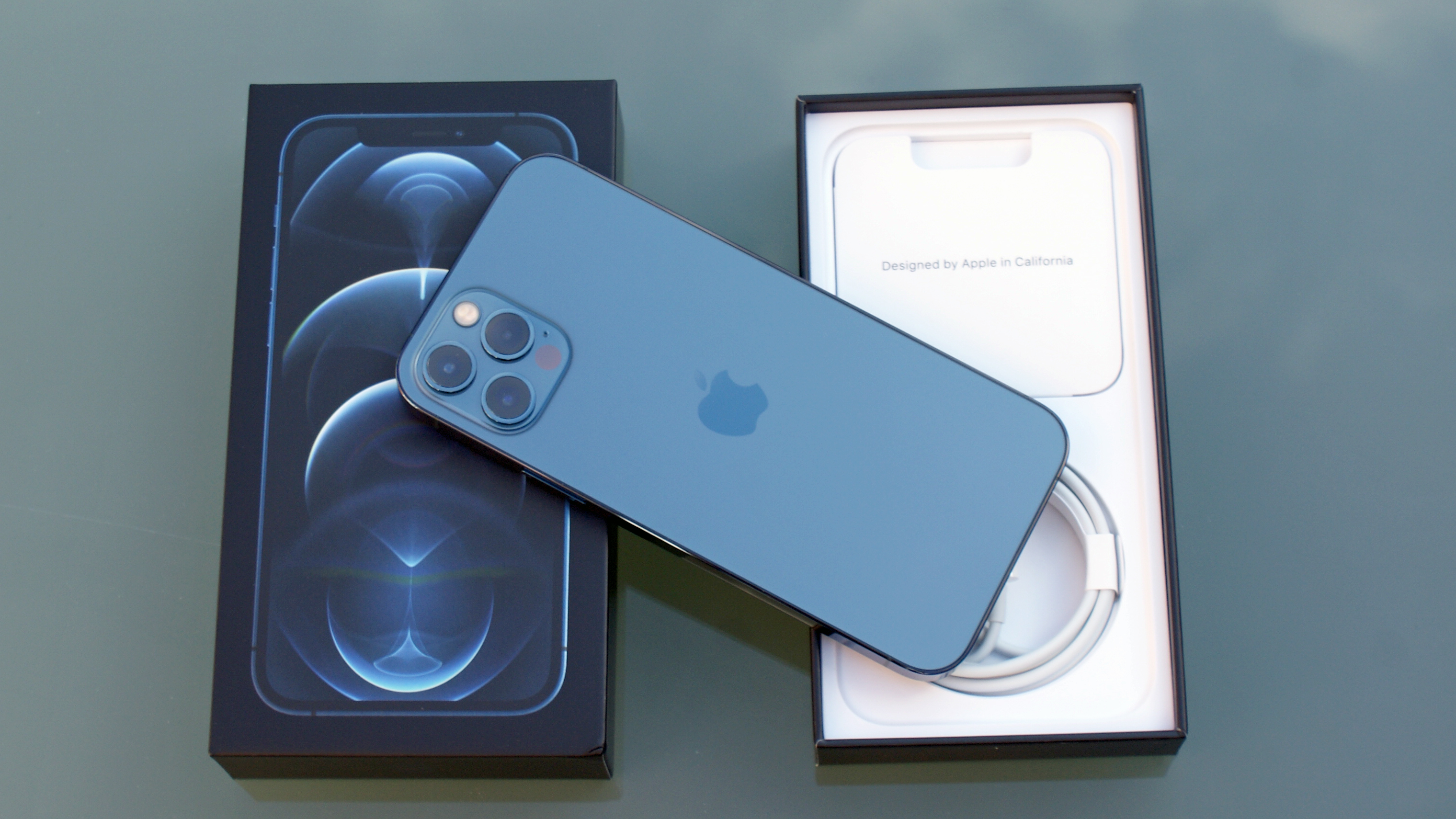 The iPhone 12 Pro sat on its retail box