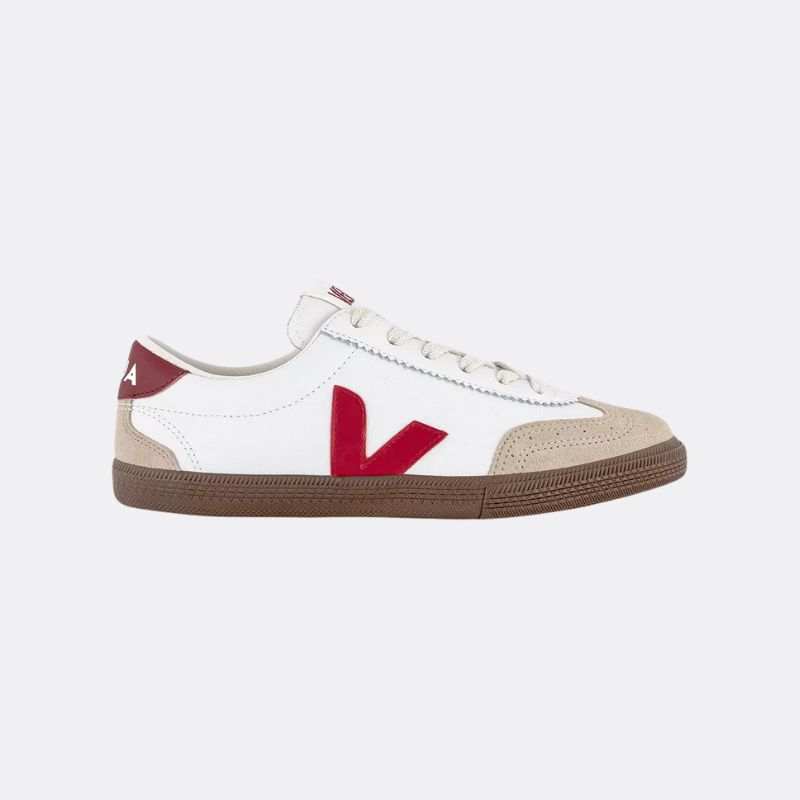 A cutout of white and red Veja trainers