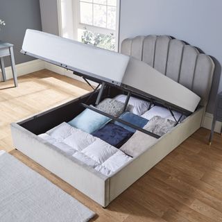 bedroom with blue wall and ottoman storage bed