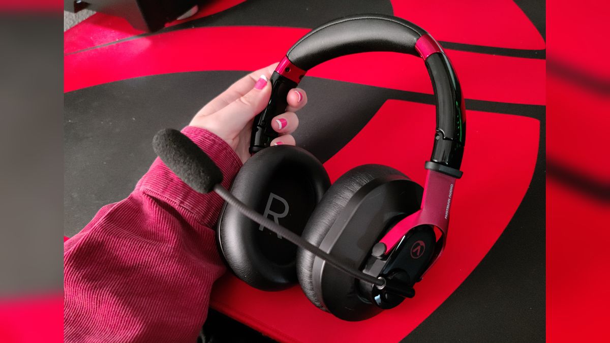 The austrian audio pg16 held against the backdrop of a red and black desk.