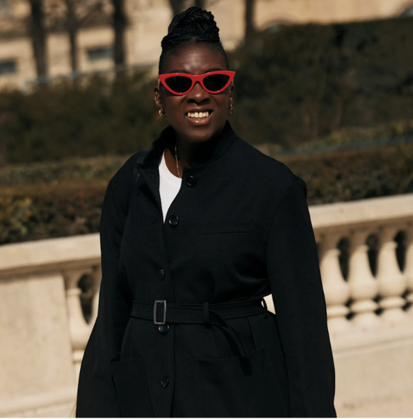 nikki ogunnaike wearing red sunglasses and a black blazer 