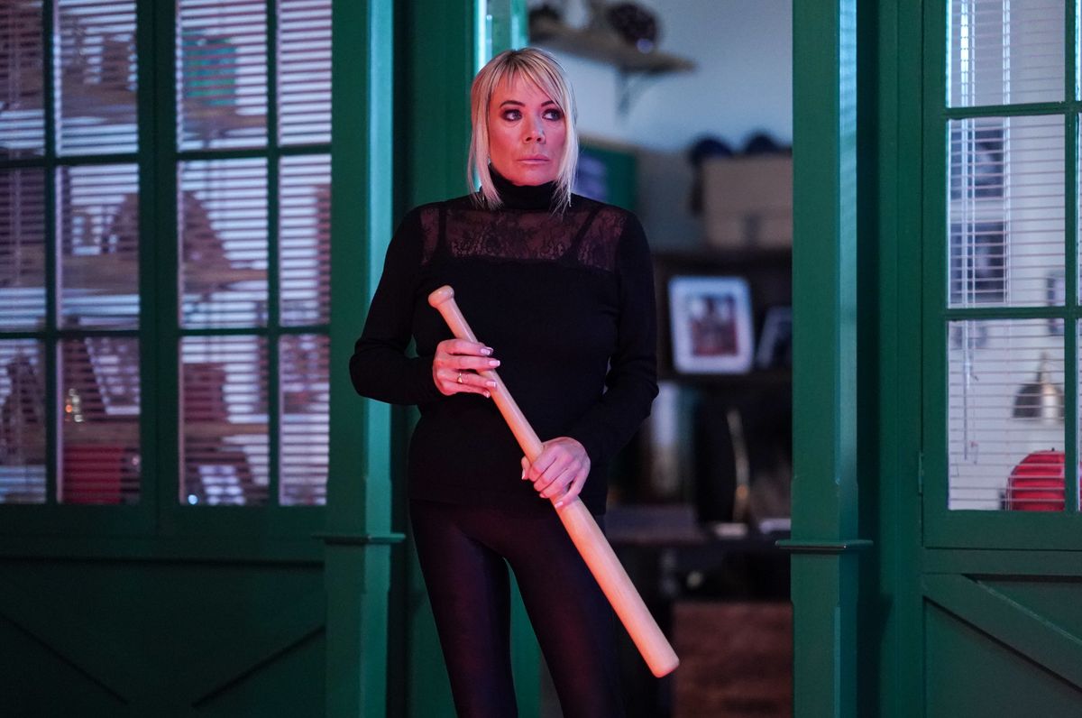 Sharon Watts holding a baseball bat.