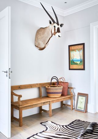 Zebra rug, wooden bench, antelope head