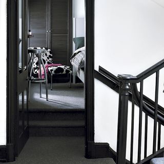 Guest bedroom with stairway and chairs