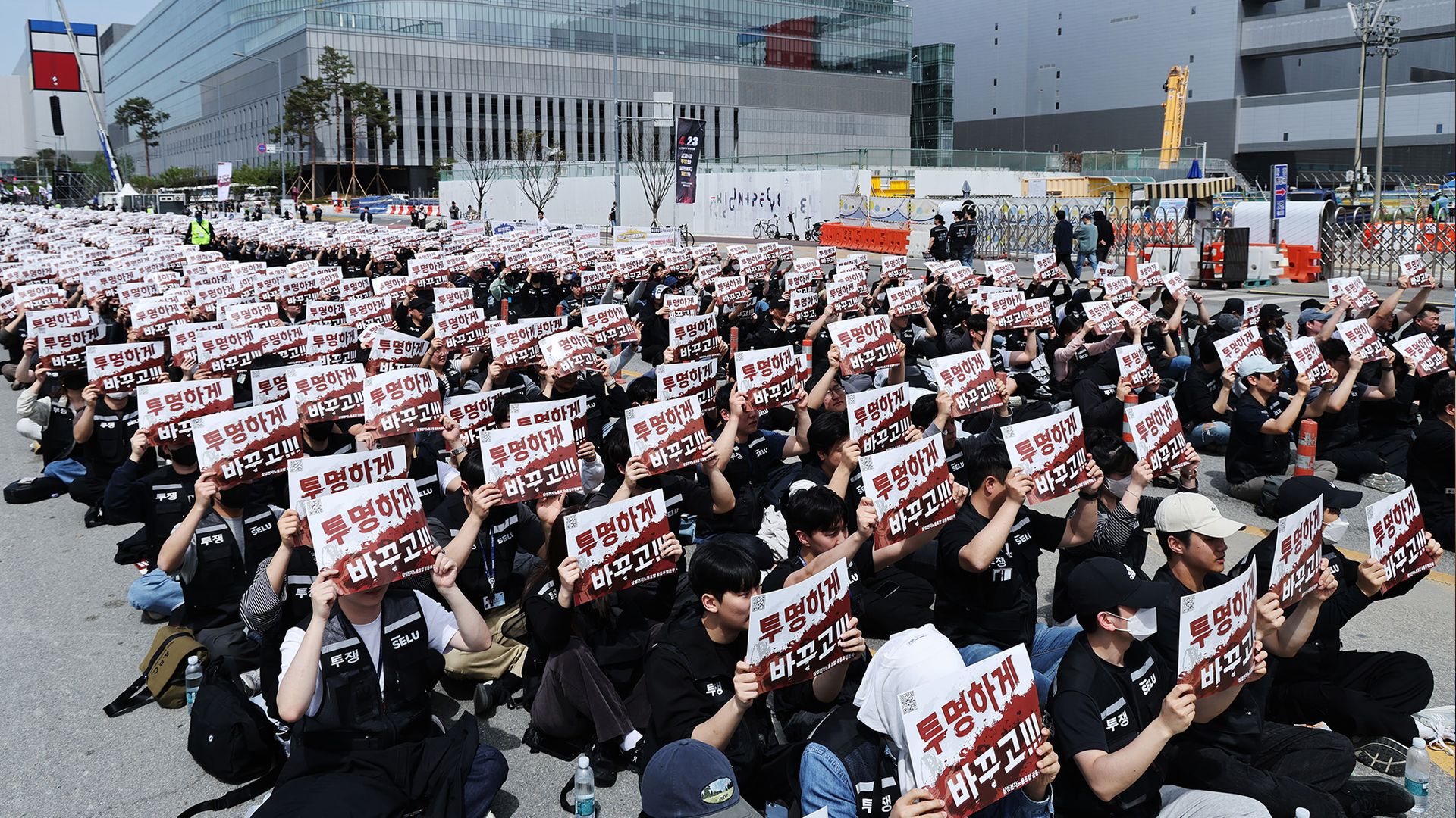 
                                Samsung union workers sit with placards during a protest in Seoul, Korea
                            