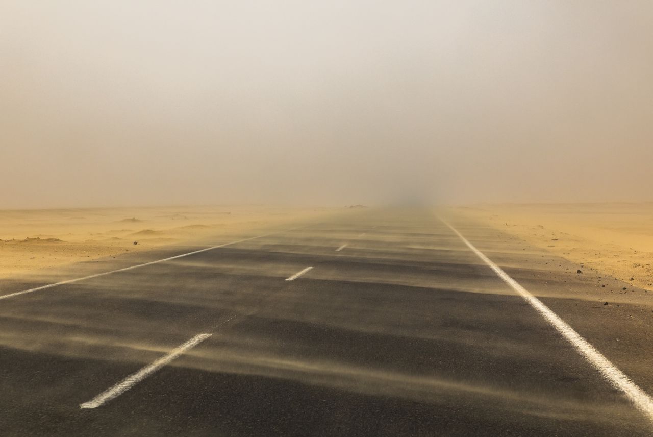 Sand storm over the road in the deser