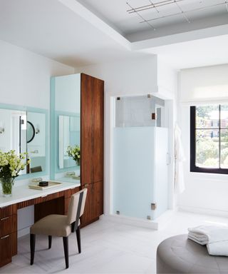 Glass shower, mirror and wooden desk