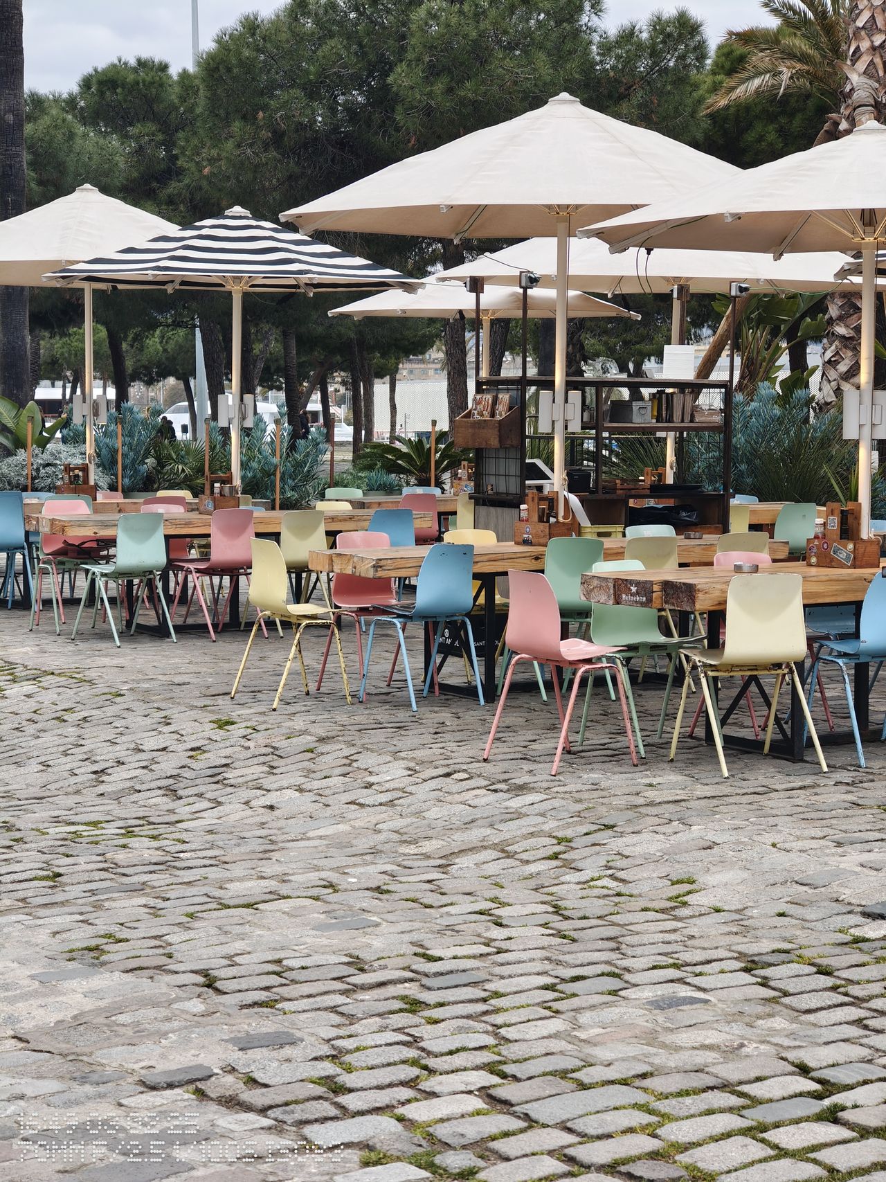 Colorful chairs under parasols in a bar