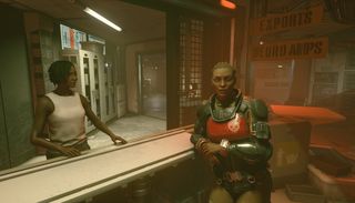 Starfield - two characters in crimson gear sit inside the space station city The Key