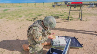 A PLA soldier counts gold bars during the exercise with US dollars and Taiwanese dollars in the box.