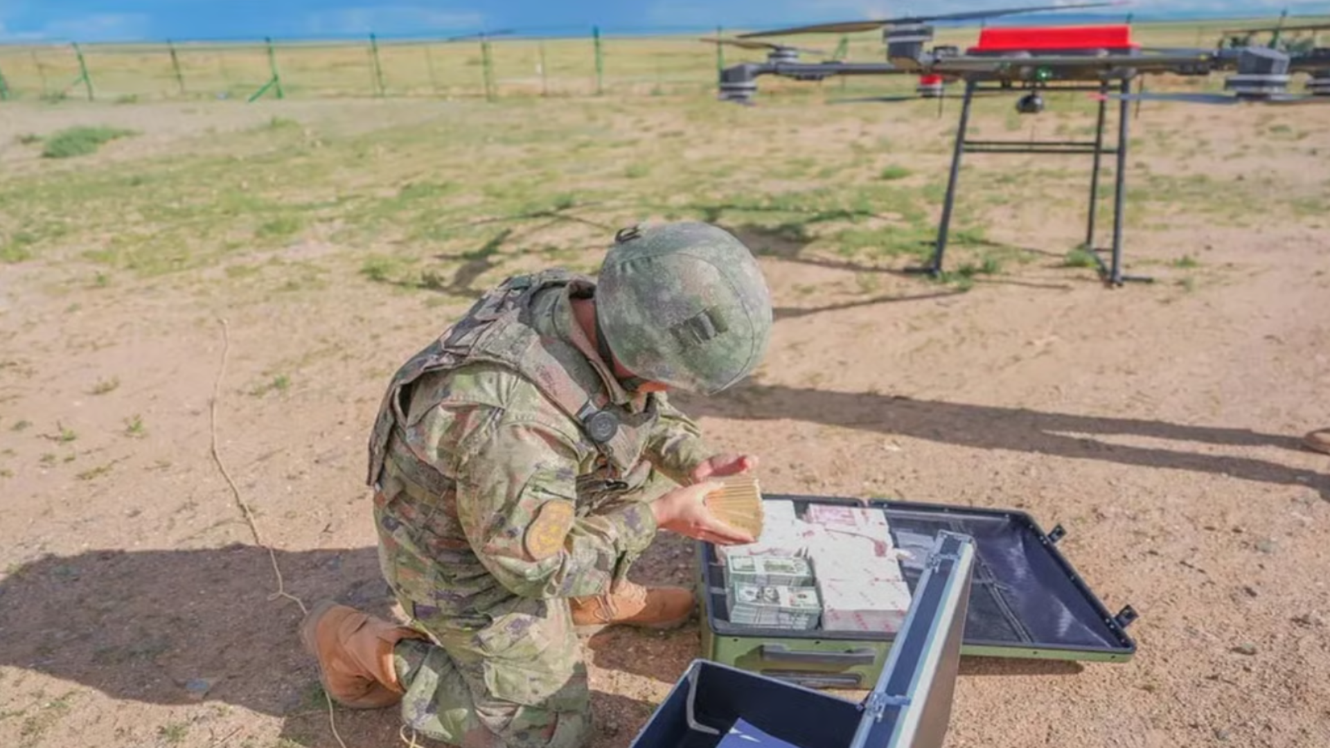 A PLA soldier counts gold bars during the exercise with US dollars and Taiwanese dollars in the box.