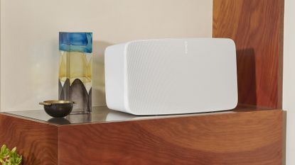 Sonos Five in white on wooden side table with ornaments