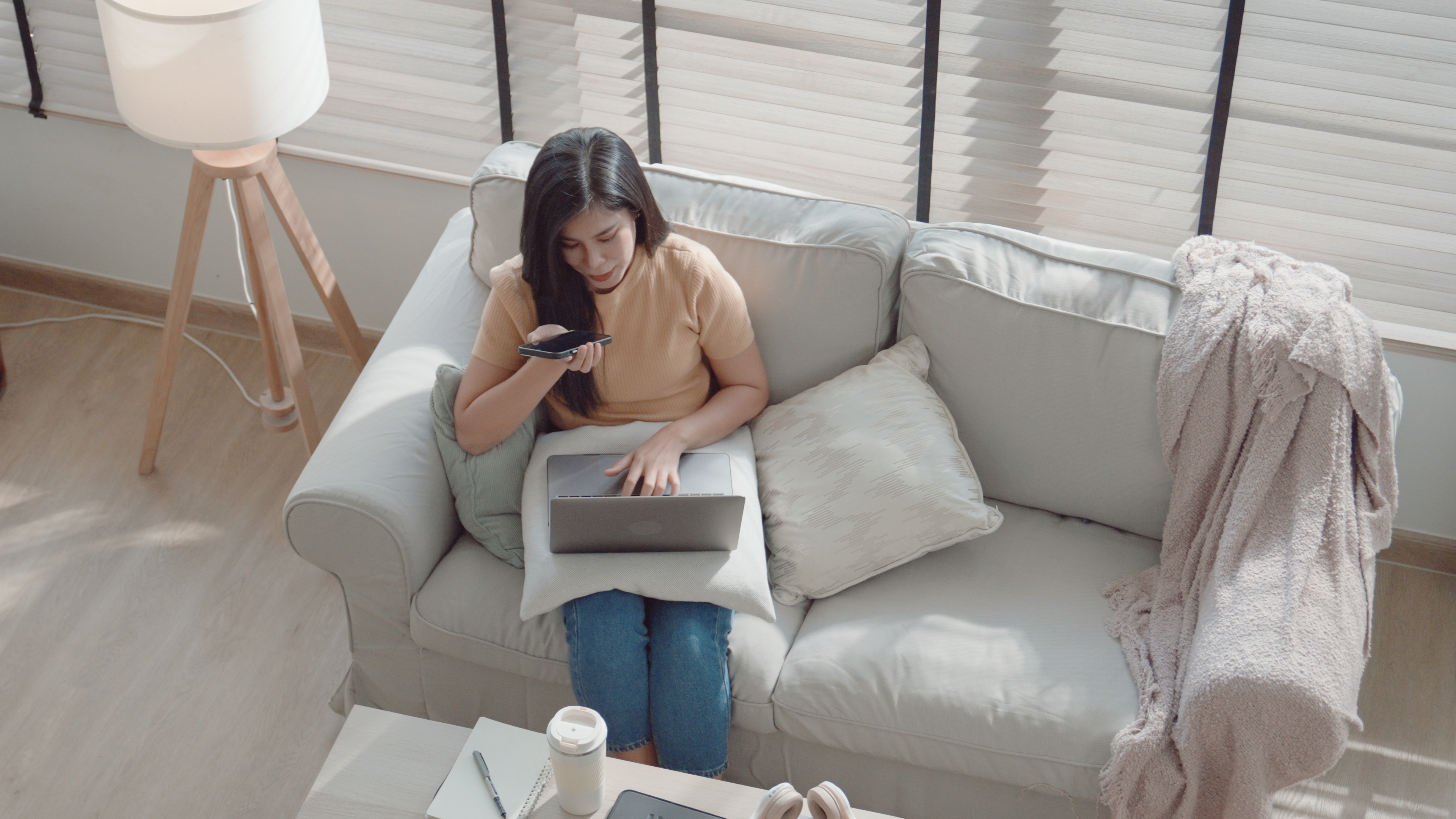 Asian woman using smartphone at home, working at home.