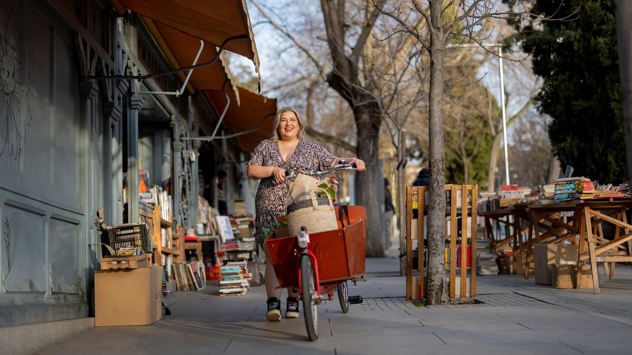 Female cyclist pushes cargo bike