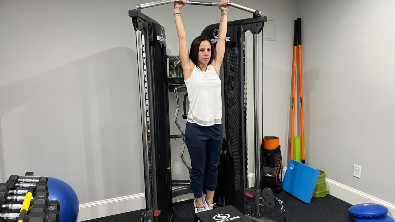 Wendy Batts in a dead hang position