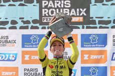 Pauline Ferrand-Prévot raises her cobbled trophy aloft