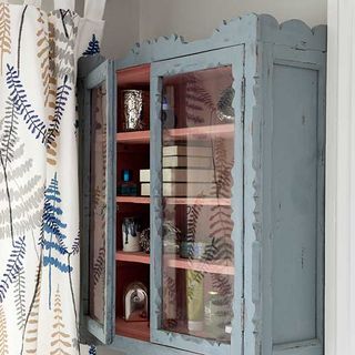 white wall with drawer and white printed curtain