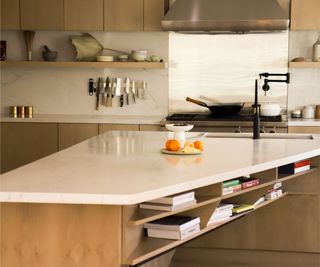 White kitchen counter, wooden cupboards and shelves