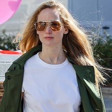 Jennifer Lawrence spotted in Los Angeles wearing a green jacket, white tee, and long denim skirt.