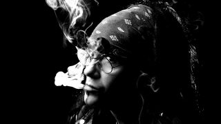 Ministry’s Al Jourgensen posing for a photograph while smoking a cigarette