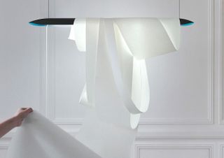 A hanging lamp with white paper wrapped around it