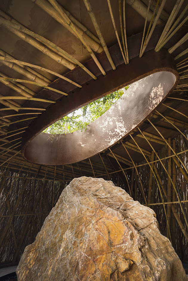 The Aranyani Pavilion seen in its green setting that highlights its natural materials and organic construction