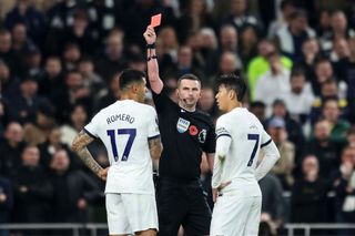 Referee Michael Oliver shows Cristian Romero of Tottenham Hotspur a straight red and sends him off during the Premier League match between Tottenham Hotspur and Chelsea FC at Tottenham Hotspur Stadium on November 06, 2023 in London, England.