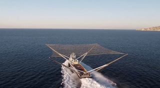 SpaceX's net-equipped boat, Mr. Steven, cruises off the California coast. SpaceX used the speedy boat to try to catch falling payload fairings, each of which costs $6 million to make.