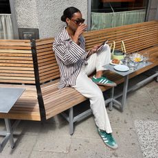 Girl sipping coffee wearing linen pants