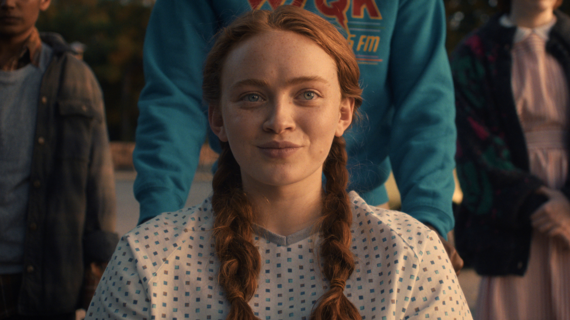 Max Mayfield (Sadie Sink) smiles as she greets her friends on Stranger Things.