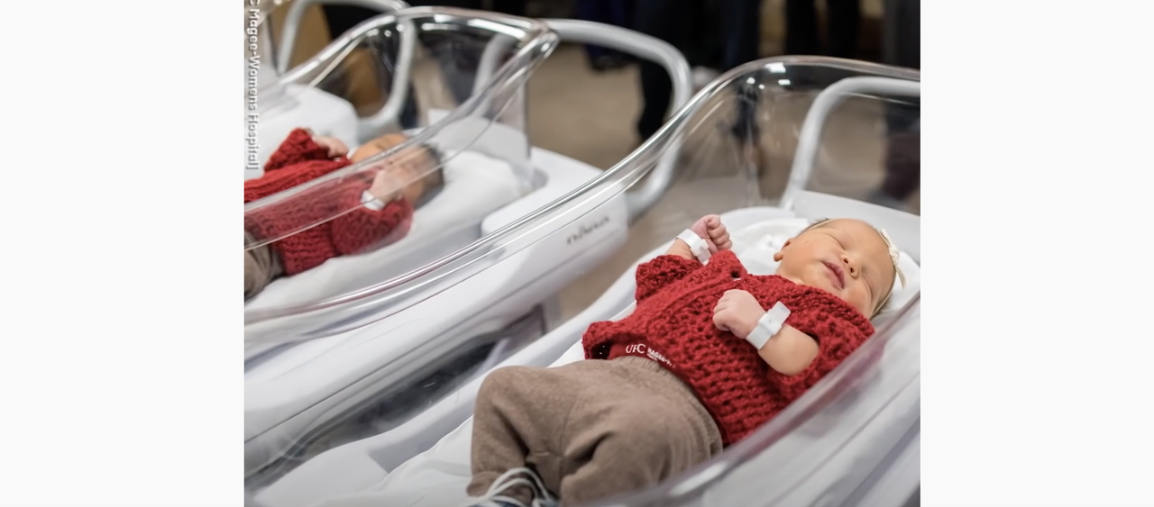 A baby dressed like Mister Rogers.