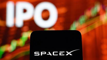 SpaceX logo on a smartphone with a blurred stock chart and the word "IPO" in the background for SpaceX IPO