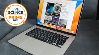 A MacBook on a sofa, with a Live Science Prime Day logo next to it.