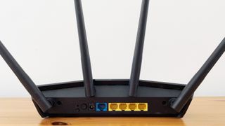 Asus RT-AX55 on a wood desk