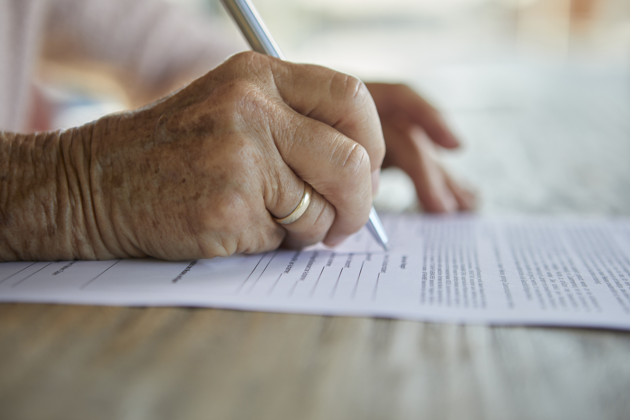 Older woman signs life insurance policy