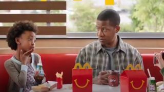 A dad and his daughter eat at McDonald's.