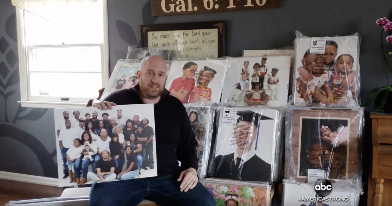 Brian Bononi holds a portrait he found in an abandoned studio.