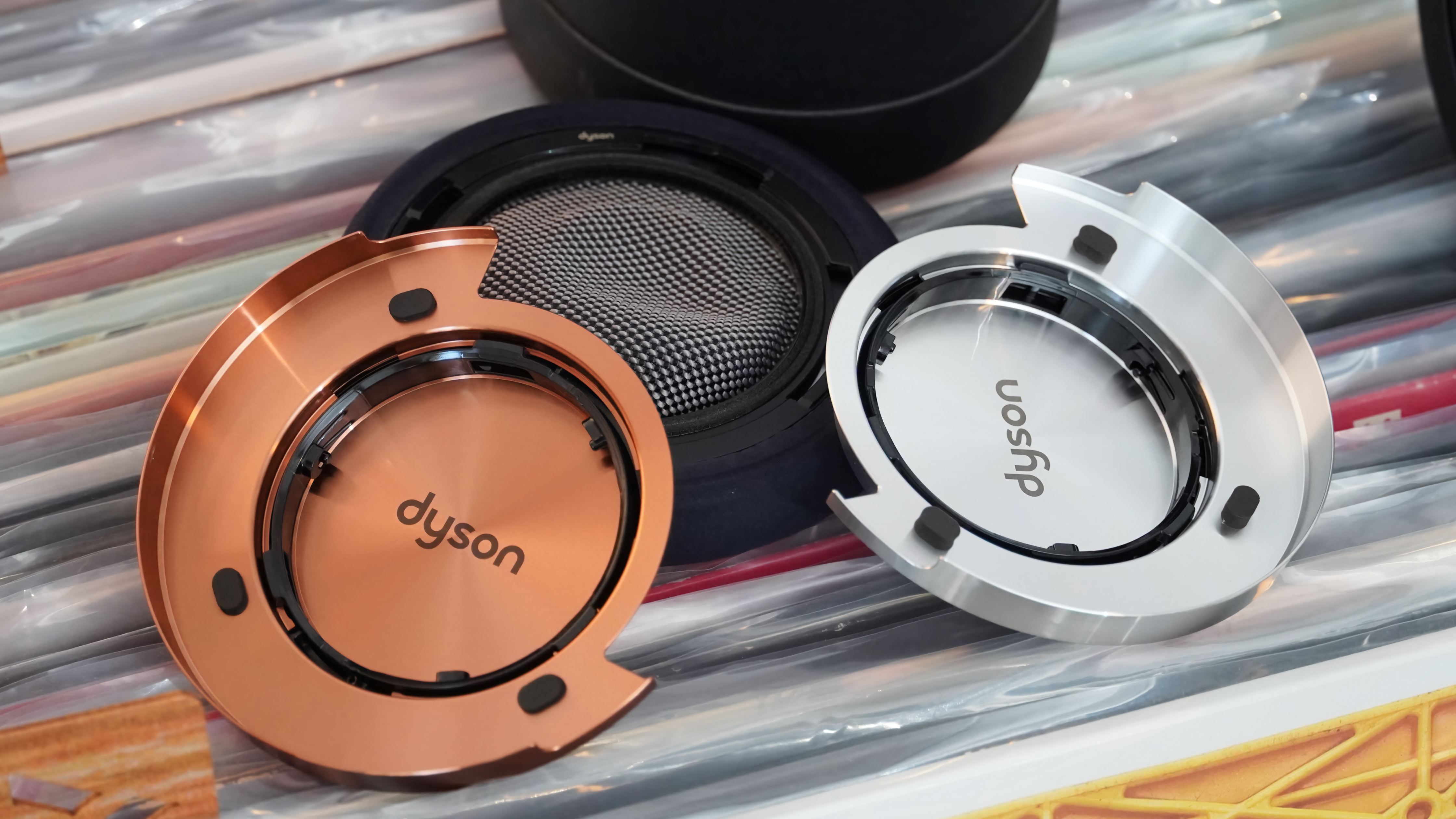 The Dyson OnTrac headphones with a mix of silver and copper caps.
