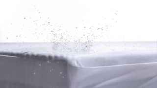 Water splash atop a white mattress protector