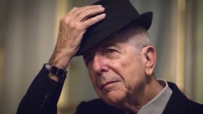Canadian singer and poet Leonard Cohen takes off his hat to salute on January 16, 2012 in Paris. Leonard Cohen's new album "Old Ideas" will be released in France on January 30. AFP PHOTO / JO
