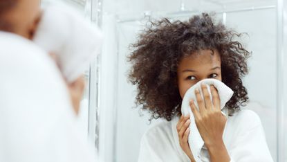 woman wiping face with cloth