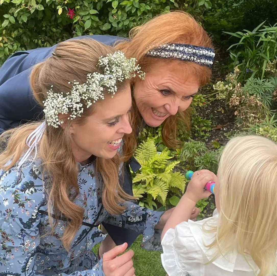 Princess Beatrice and Sarah Ferguson wearing blue dresses and smiling at Sienna Mapelli Mozzi