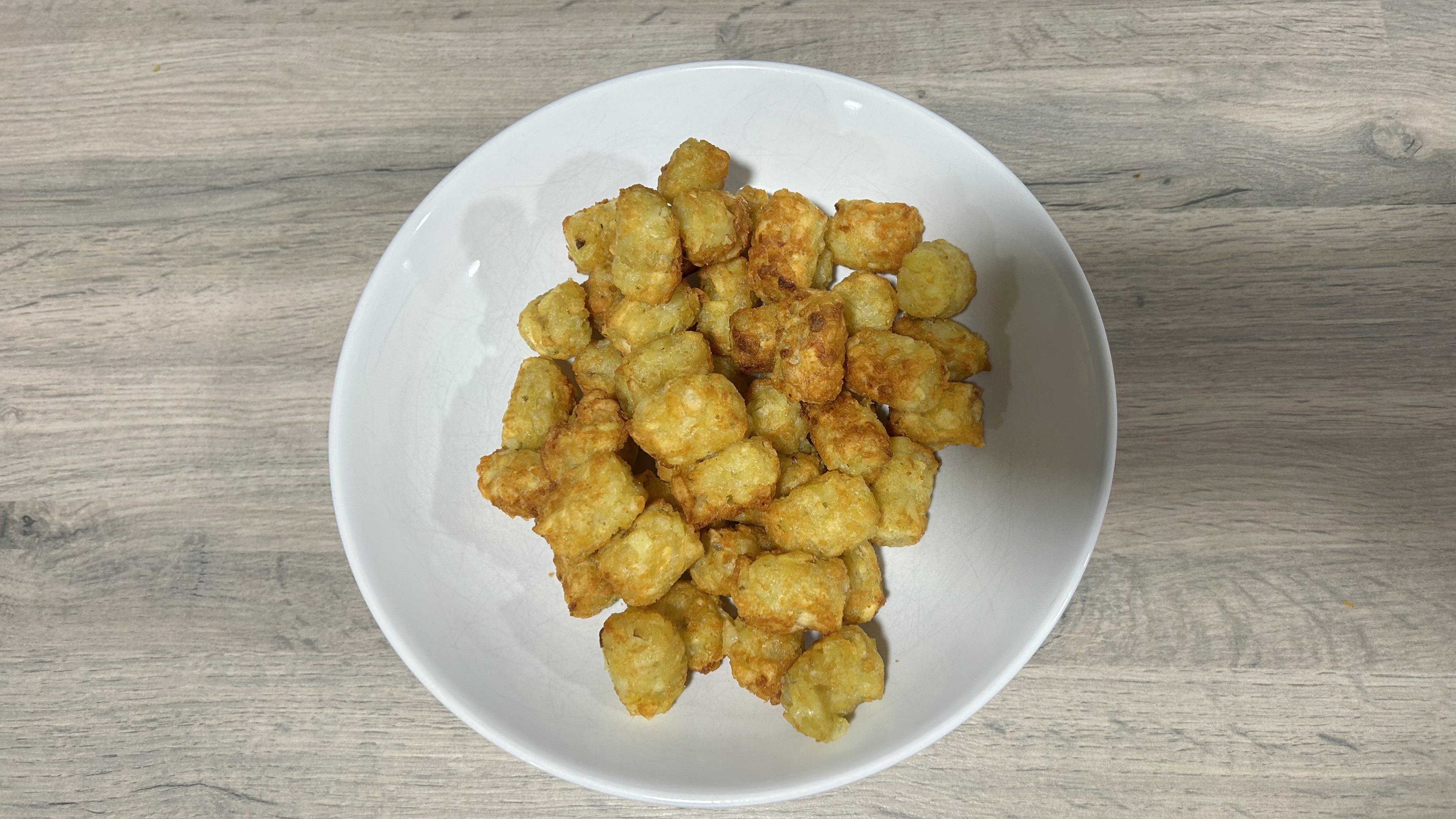 Image of tater tots cooked in the Philips 1000 Series FlexDrawer Air Fryer.